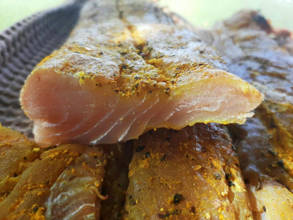 a close up of a piece of bread with a ham at La Table d Alexandre Gîte de charme entre mangrove et mer in Hell-Ville