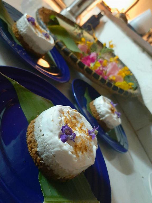 a blue plate with a donut on top at La Table d Alexandre Gîte de charme entre mangrove et mer in Hell-Ville