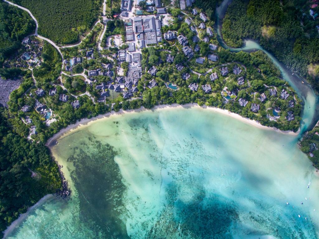 an aerial view of a beach with turquoise water at Constance Ephelia in Port Glaud