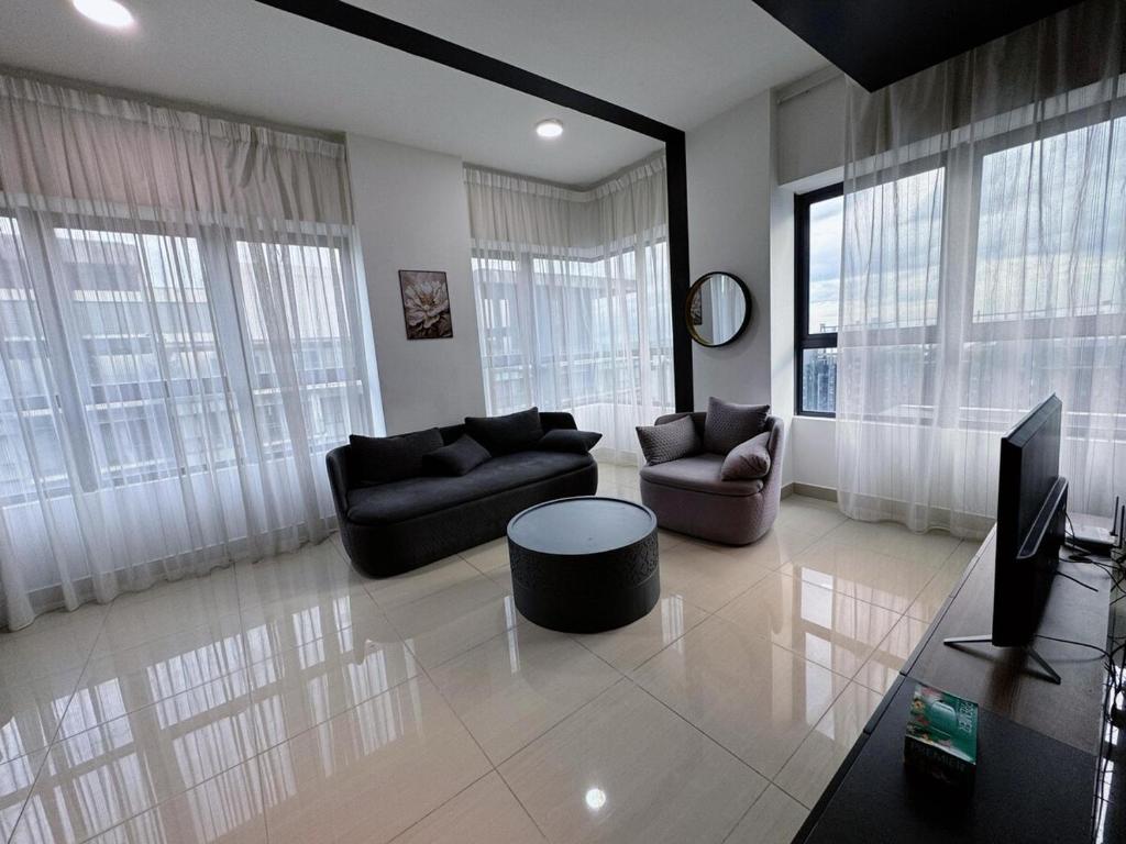 a living room with two couches and a tv at Arte Plus Ampang City 7Pax-3BR-2CP in Kuala Lumpur