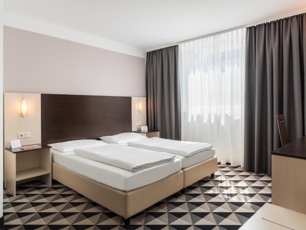 Postel nebo postele na pokoji v ubytování Premier Inn Wien City Hauptbahnhof