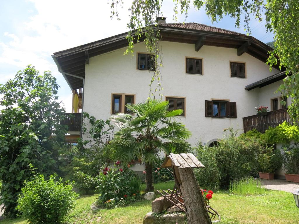 una casa nel giardino con un albero di Wertischer Hof a Termeno