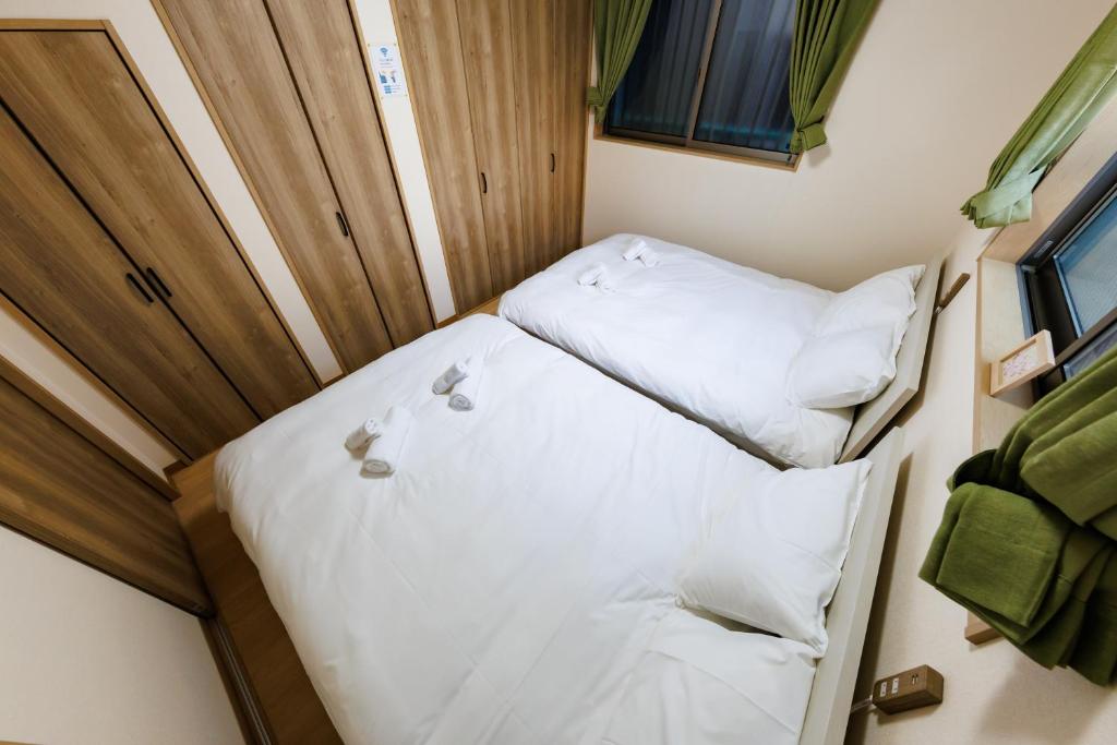 Postel nebo postele na pokoji v ubytování 新大阪旅庵 民泊縁家