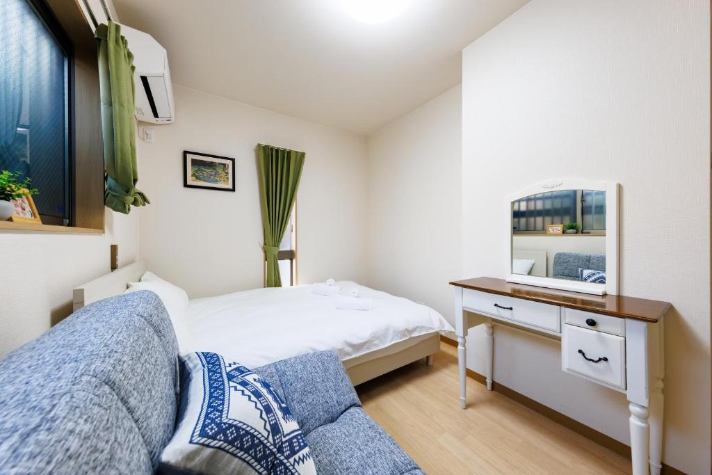 Postel nebo postele na pokoji v ubytování 新大阪旅庵 民泊縁家