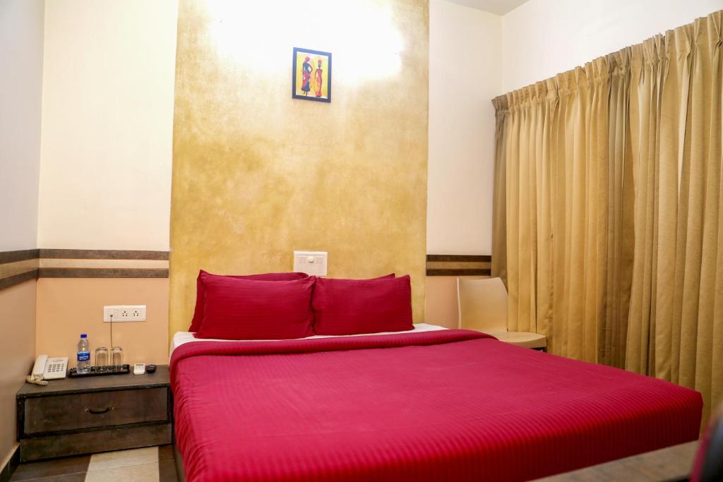 Postel nebo postele na pokoji v ubytování Hotel Sapthagiri Nest