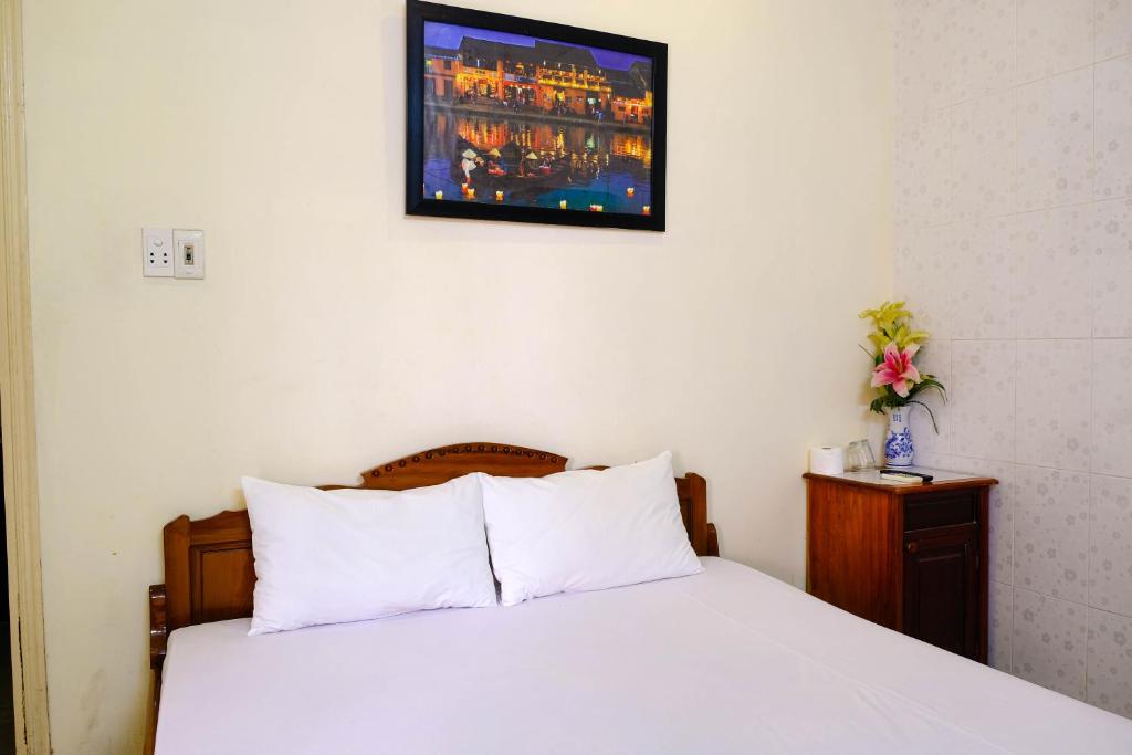 Postel nebo postele na pokoji v ubytování Lucky Hội an Hotel