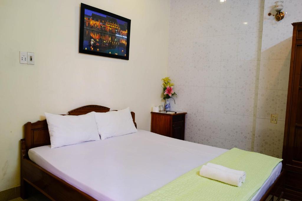 Postel nebo postele na pokoji v ubytování Lucky Hội an Hotel