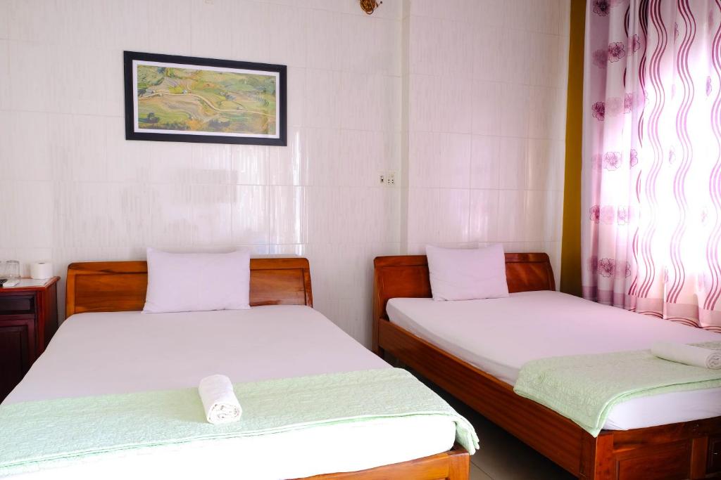 Postel nebo postele na pokoji v ubytování Lucky Hội an Hotel