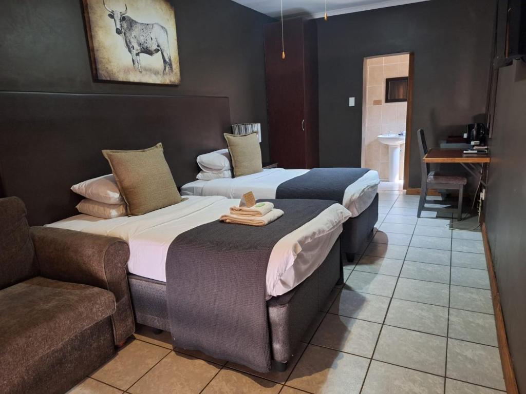 Postel nebo postele na pokoji v ubytování Kusile Guest House