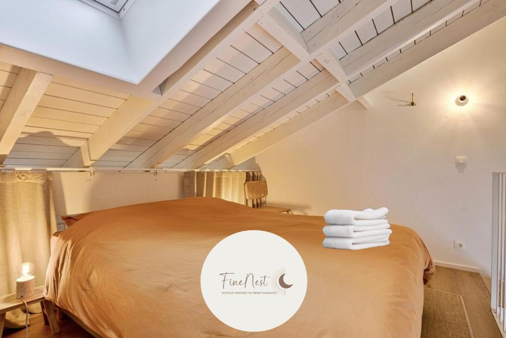 a bedroom with a large bed with towels on it at Loft City Center - 1 bedroom - parking - by FineNest in Liège