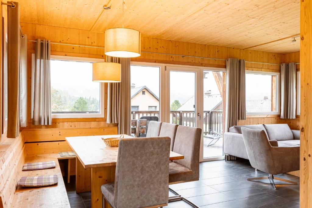 a dining room with a table and chairs at Almdorf Hohentauern by ALPS RESORTS in Hohentauern