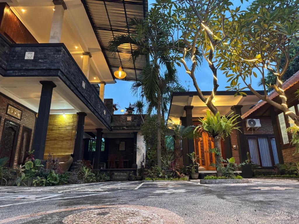 a house with a lot of trees in front of it at Murni’s House in Lovina