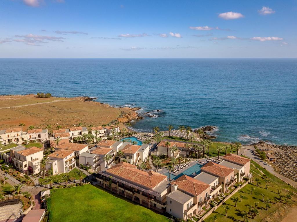 an aerial view of a resort near the ocean at Grecotel Marine Palace & Aqua Park in Panormos Rethymno