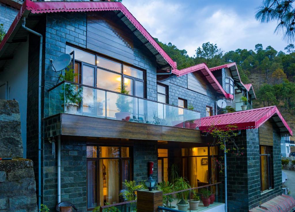 a house with large glass windows on it at Alaya Stays Kasauli Woods Cottage 3 BHK Retreat with Outdoor Lounge & Balcony in Patta