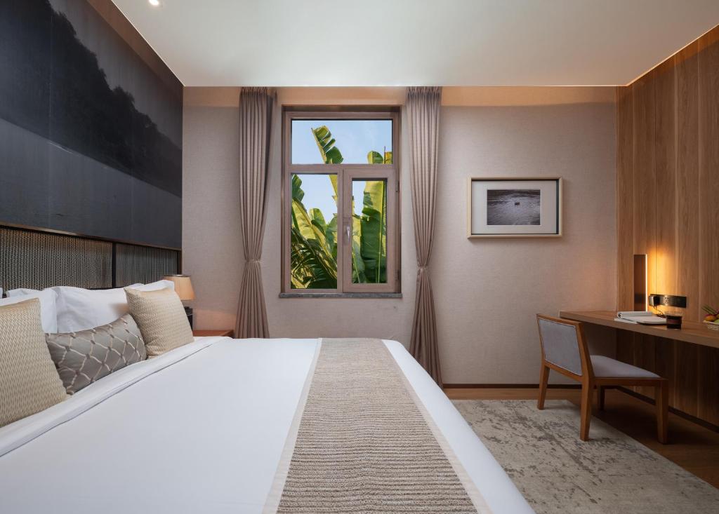 Postel nebo postele na pokoji v ubytování Yunjian Hotel