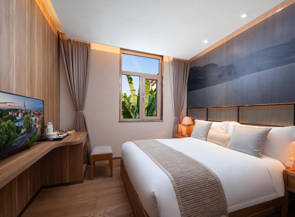 Postel nebo postele na pokoji v ubytování Yunjian Hotel