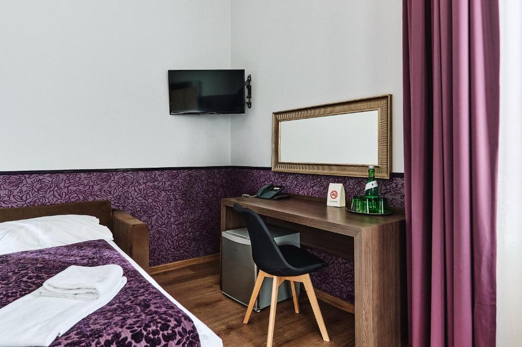 Postel nebo postele na pokoji v ubytování Hotel Pension Baron am Schottentor