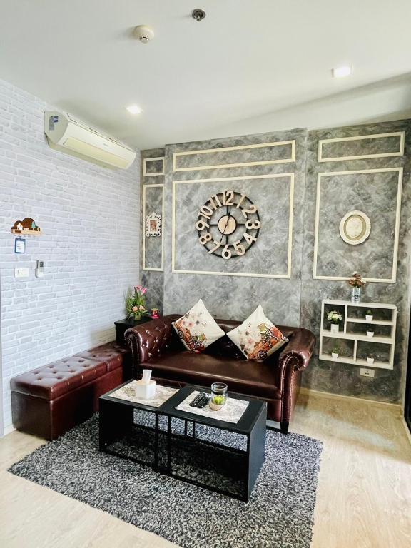 a living room with a leather couch and a table at The base Condo luxury room by Numam in Pattaya