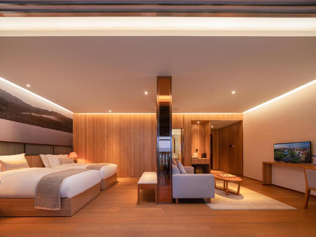 Postel nebo postele na pokoji v ubytování Yunjian Hotel