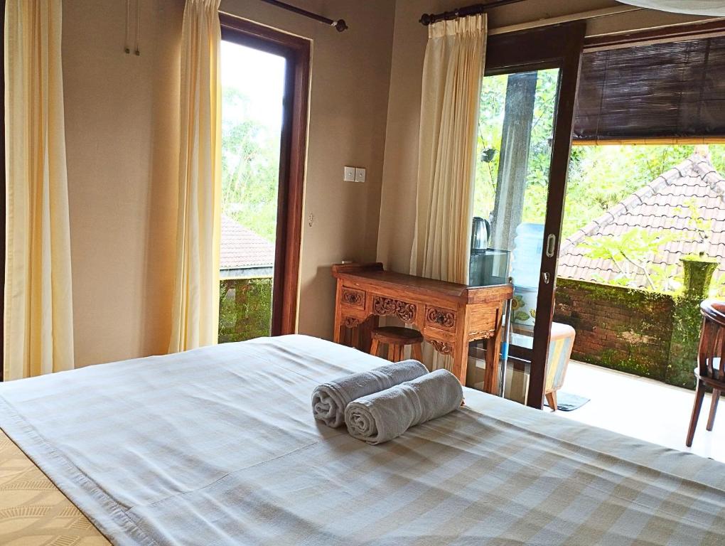 Postel nebo postele na pokoji v ubytování Umah Ubud Guest House