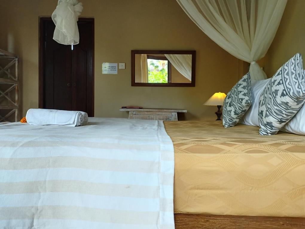 Postel nebo postele na pokoji v ubytování Umah Ubud Guest House