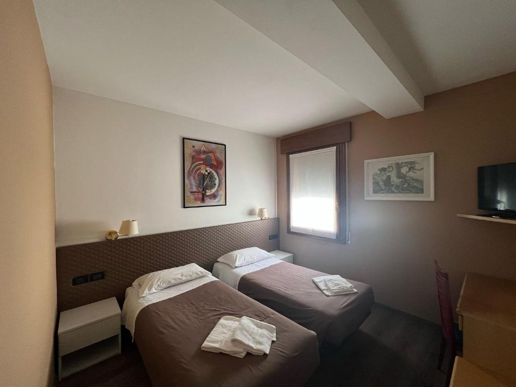 Postel nebo postele na pokoji v ubytování Damodoro Hotel