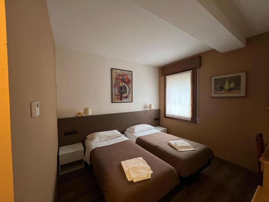 Postel nebo postele na pokoji v ubytování Damodoro Hotel