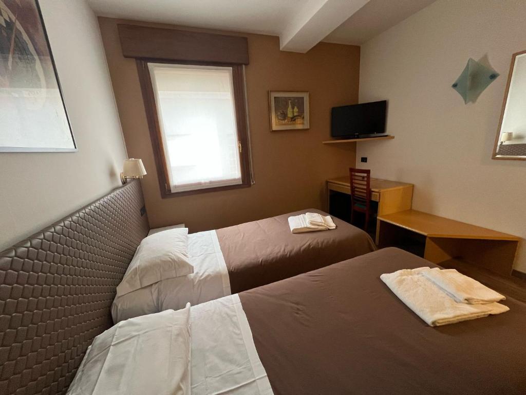 Postel nebo postele na pokoji v ubytování Damodoro Hotel