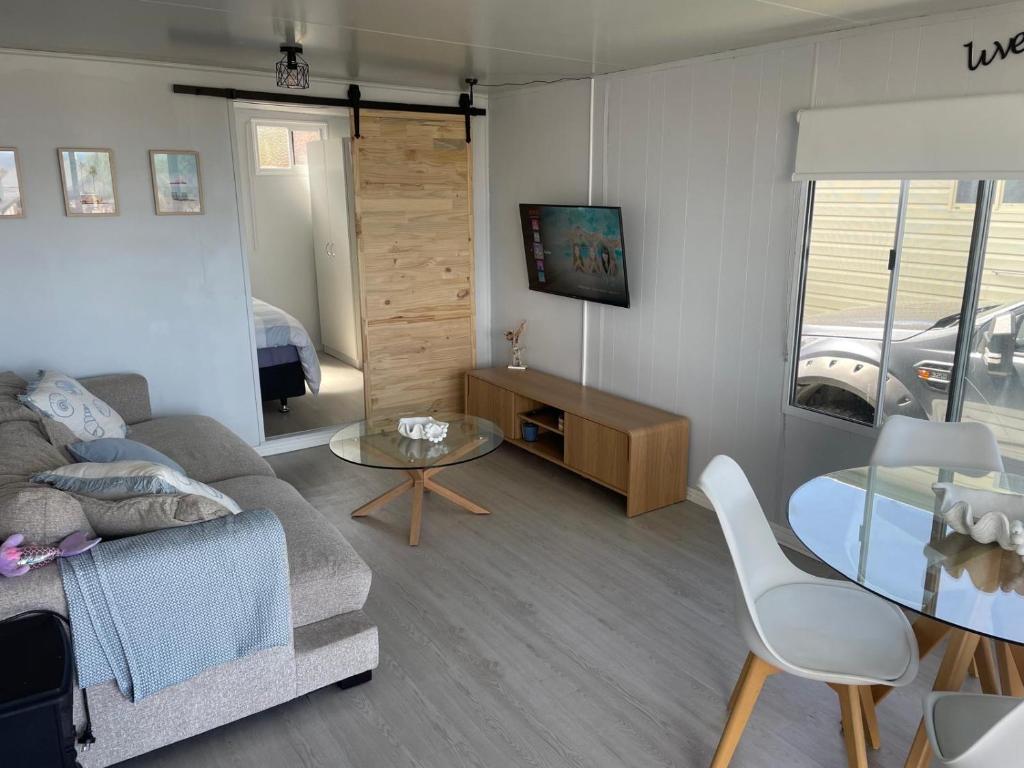 TV a/nebo společenská místnost v ubytování Cozy Cabin by the beach