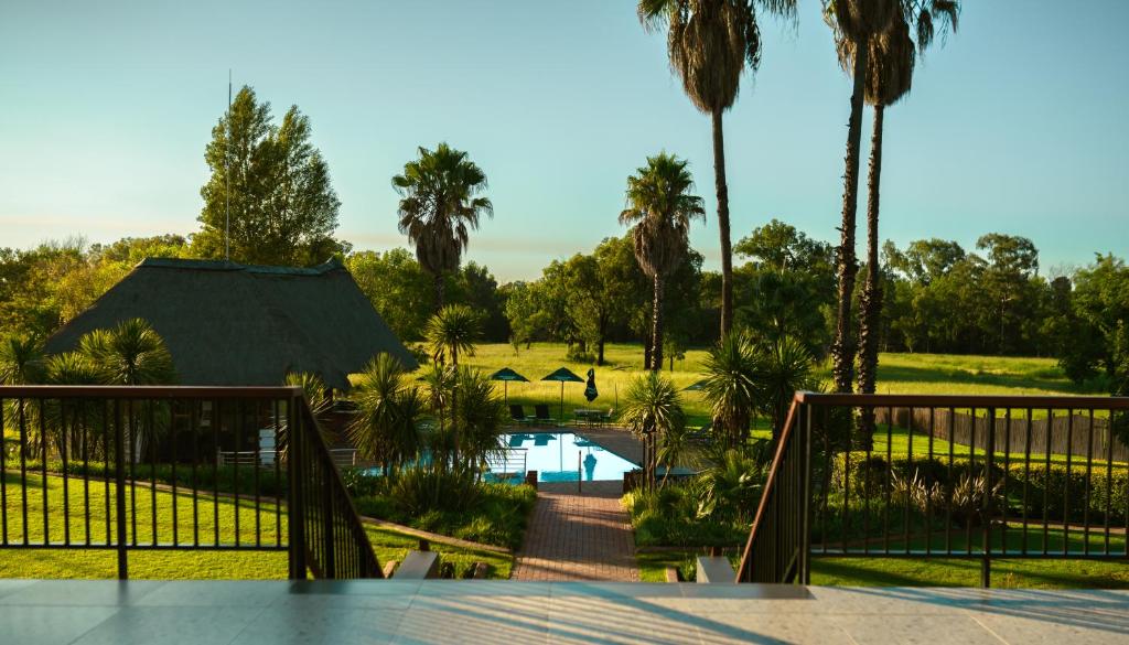 a view of a resort with a pool and palm trees at Emerald Resort & Casino in Vanderbijlpark