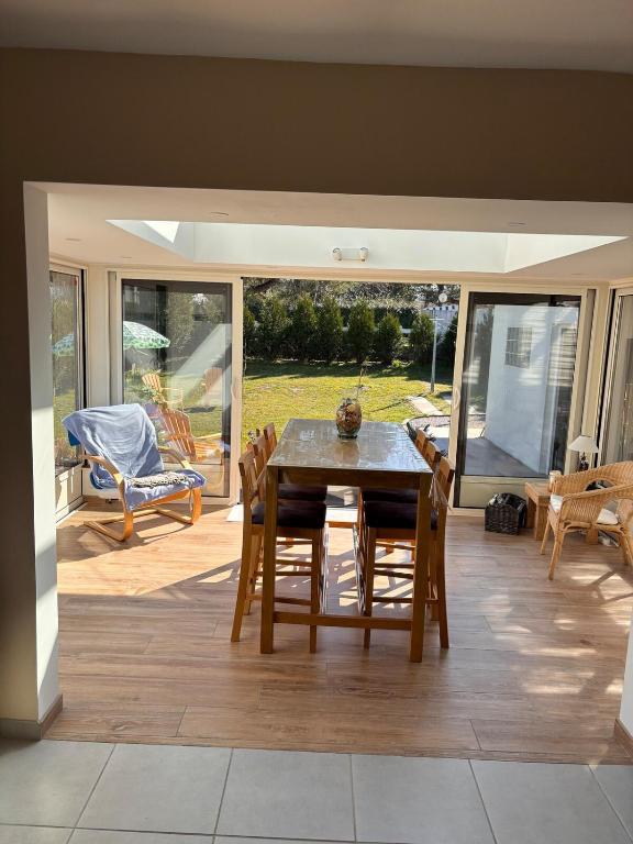 a dining room with a table and chairs on a patio at La CaMaNi in Quend-Plage