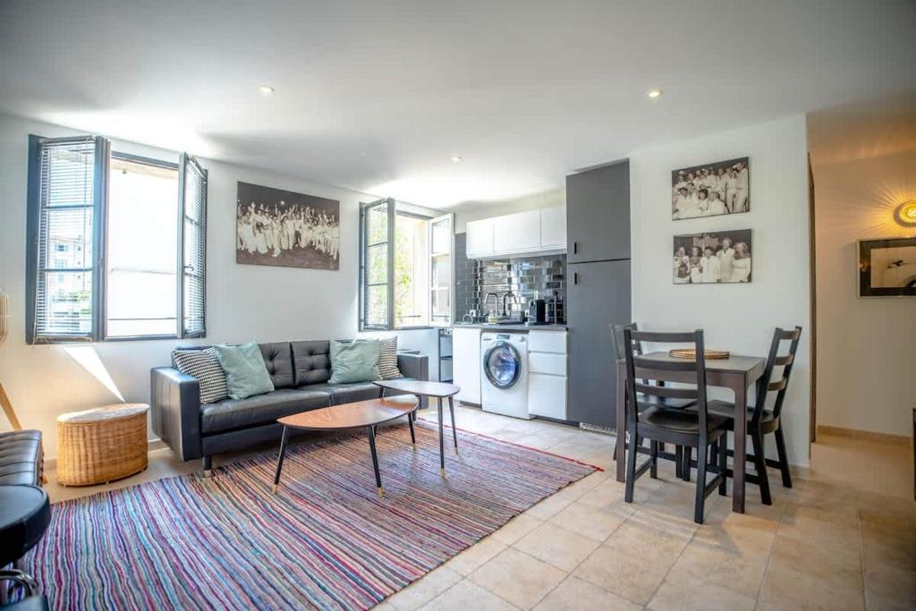 a living room with a couch and a table at Les Lices B l Equiped & Central l Shellter Rentals in Saint-Tropez