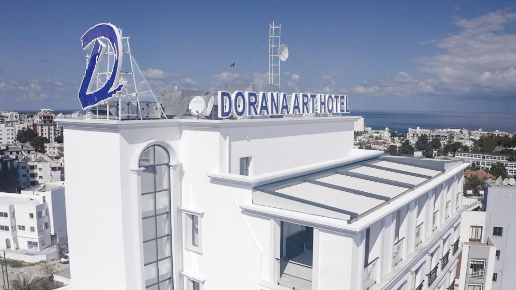 a white building with a sign on top of it at Dorana Art Hotel in Kyrenia