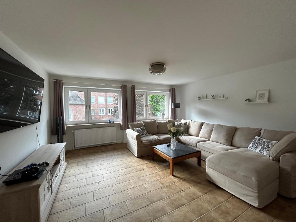 a living room with a couch and a table at Ferienwohnung Familie Reiprich in Bremerhaven