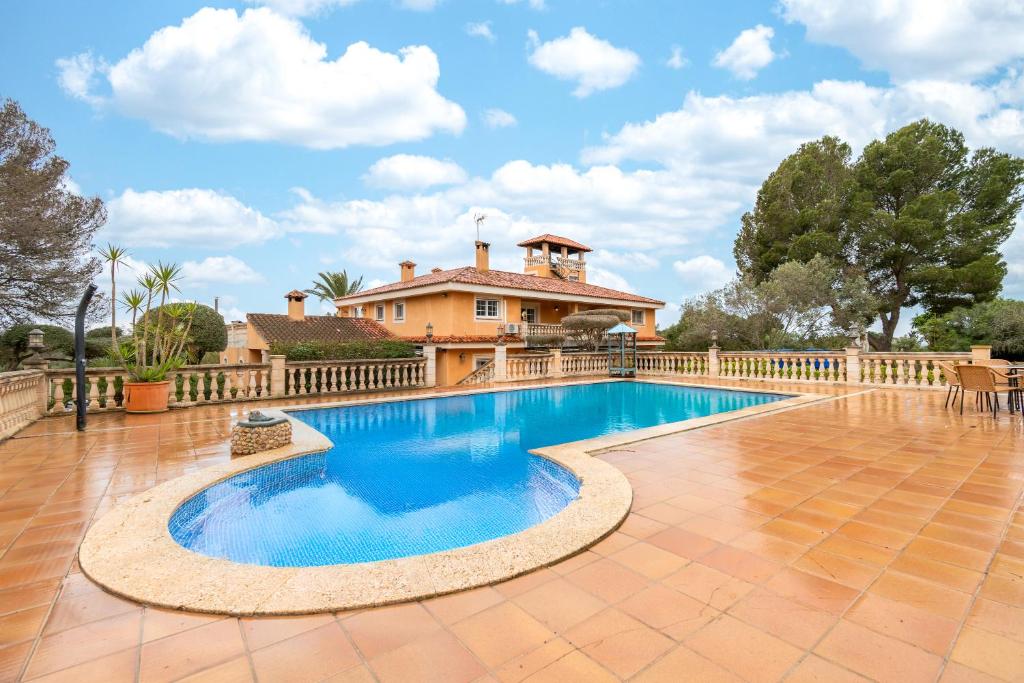 a swimming pool in front of a house at Casa Alegria in Pòrtol