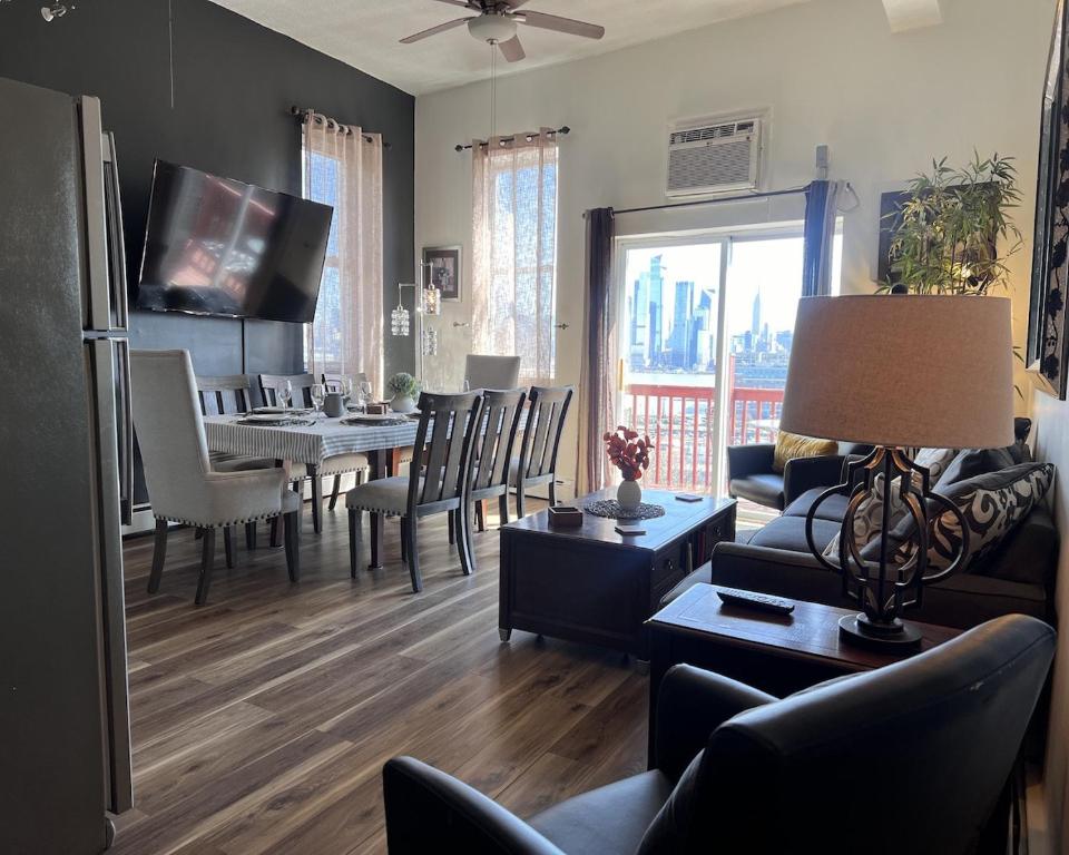 a living room with a table and a dining room at Mega See NY Now - Midtown - Apt 1 & 2 Combo in Union City