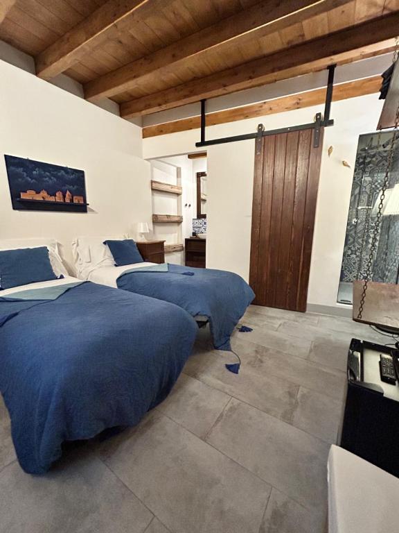 A bed or beds in a room at Locanda Sette Fate SPA e Solarium