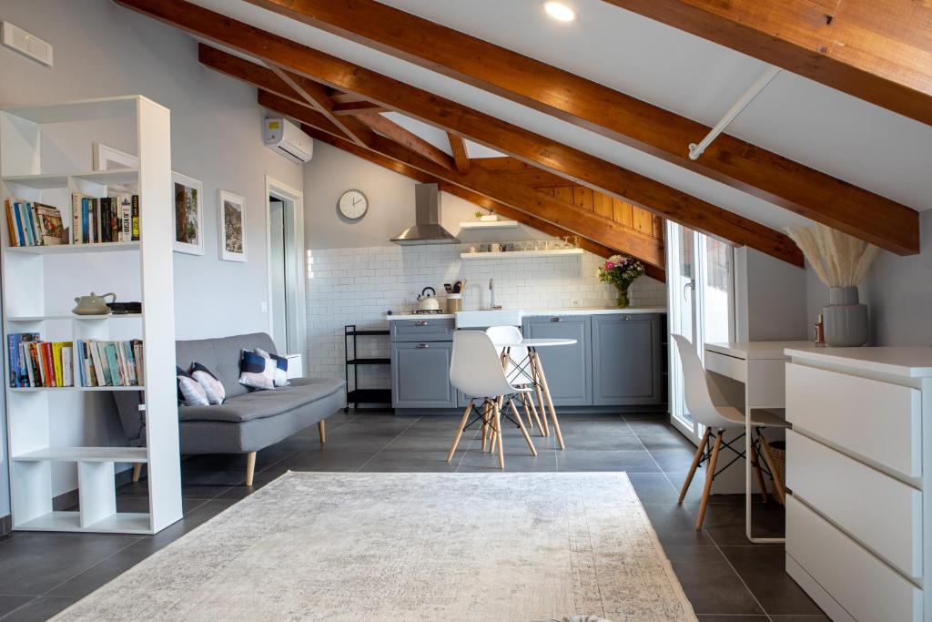 a kitchen and living room with a couch and a table at The Cliff Amalfi Coast - Apartment 1 in Pianillo