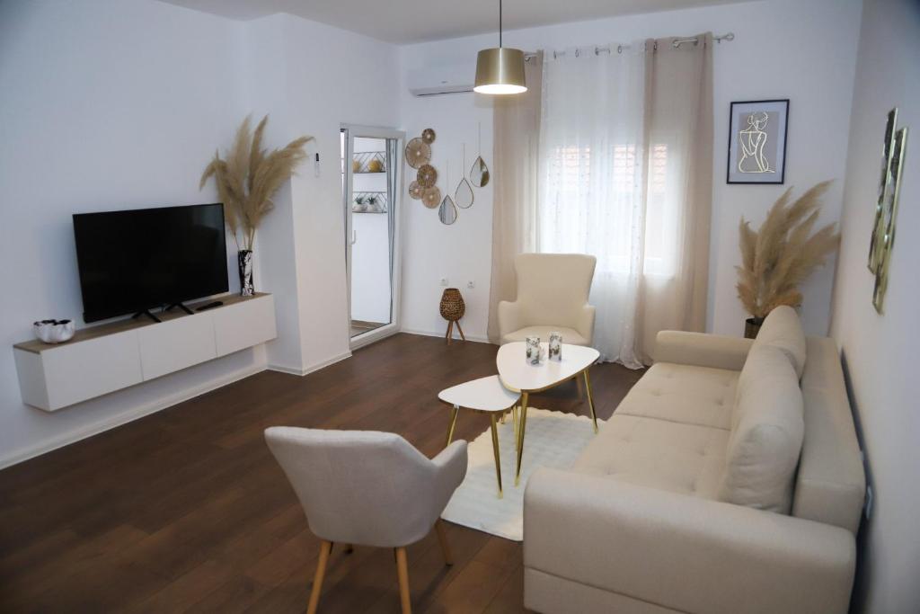 a living room with a couch and a table at Mostar Comfort Suites in Mostar