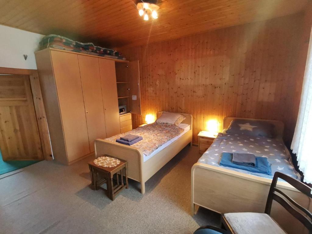a small room with two beds and a cabinet at Haus der Könige in Wietzendorf