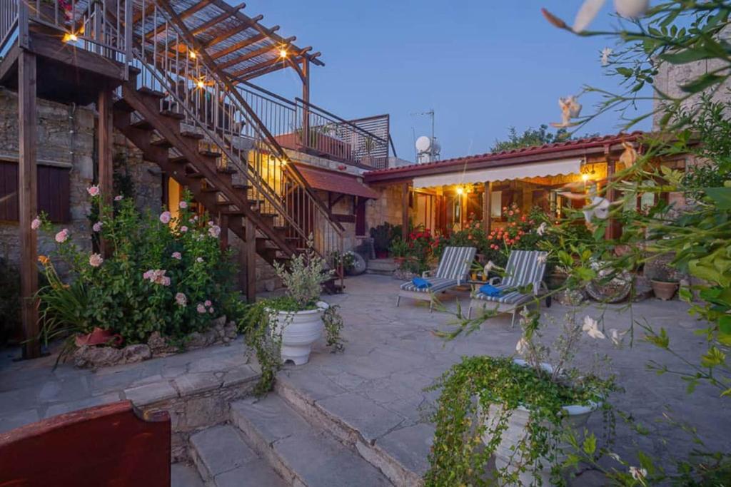 a patio with chairs and flowers in a house at HideAway Lasa in Lasa