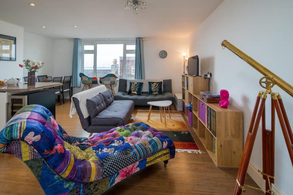 a living room with a couch and a table at Composers apartment in Cowes