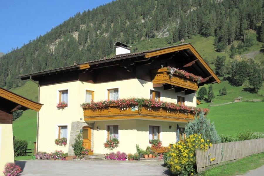 a house with flowers on the side of it at Haus Traudi in Rauris