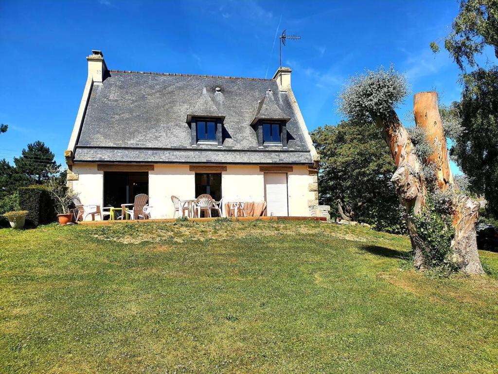 a house on top of a grassy hill at Le pré Colas- la maison néo bretonne in Pordic