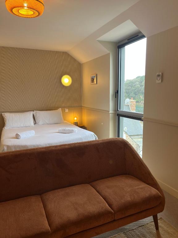 Postel nebo postele na pokoji v ubytování Hôtel BelleVue