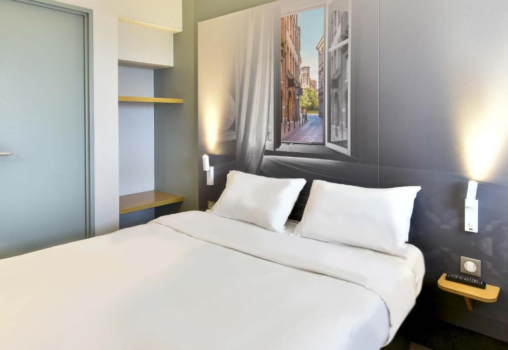 Postel nebo postele na pokoji v ubytování B&B HOTEL Toulouse Cité de l'Espace Mouchotte