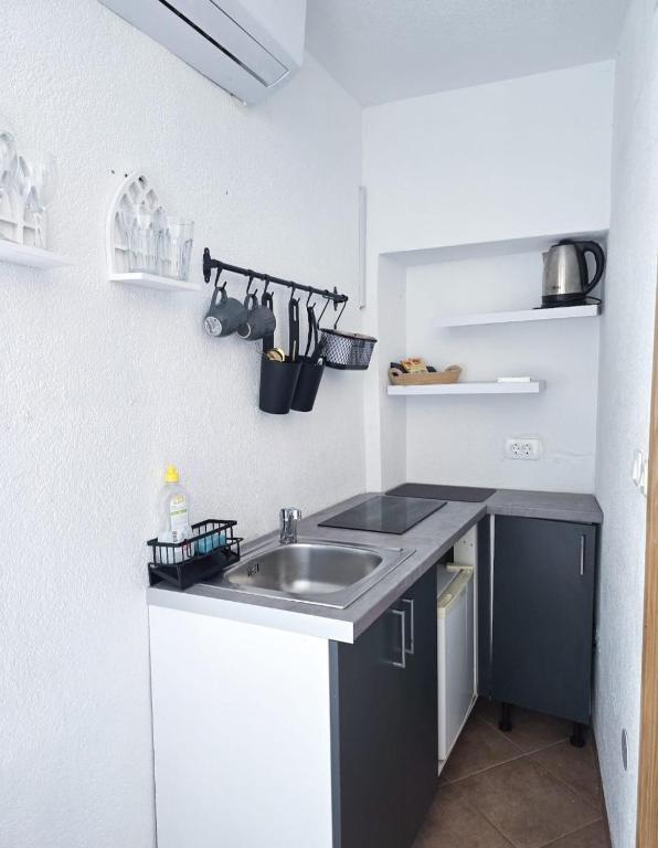 a kitchen with a sink and a counter at Private bedroom with bathroom in Baška Voda