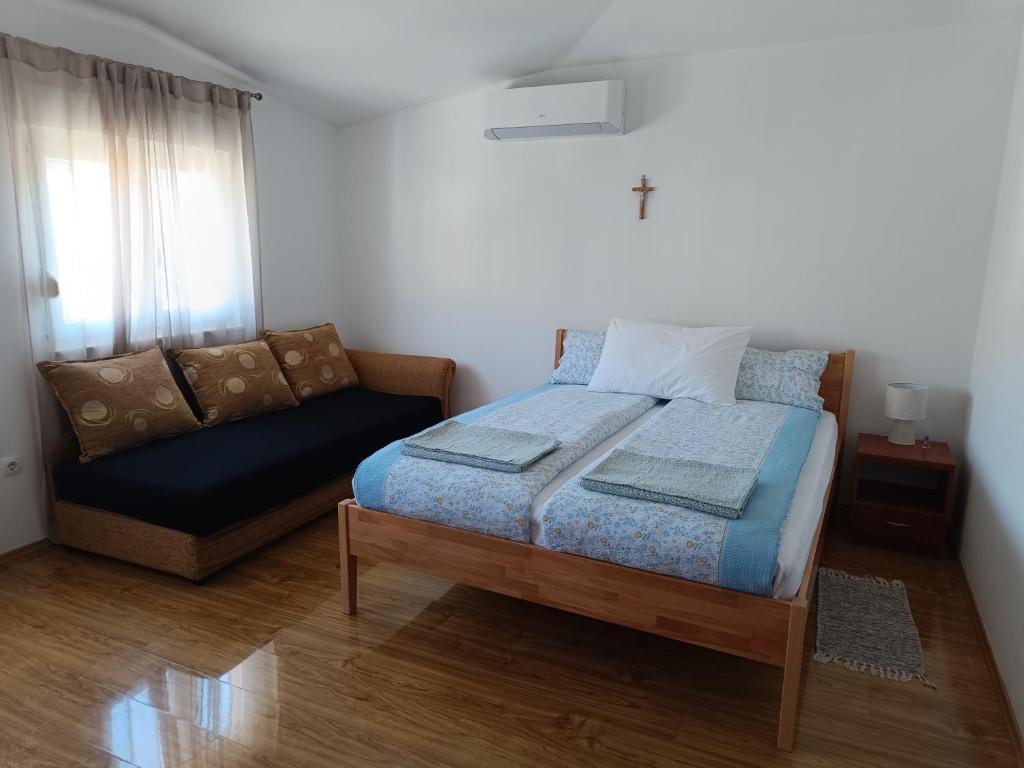Postel nebo postele na pokoji v ubytování Studio Apartman Totus Tuus