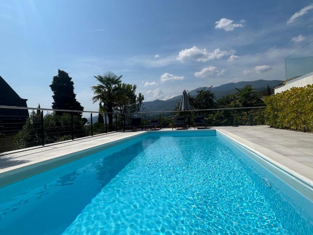 a swimming pool with blue water in a house at Ars Vivendi in Opatija