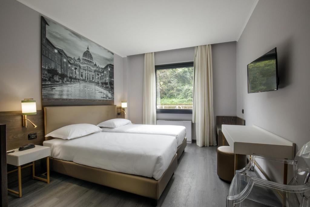 Postel nebo postele na pokoji v ubytování Hotel Marc'Aurelio